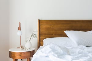Canva - White Bedspread Beside Nightstand With White and Copper Table Lamp